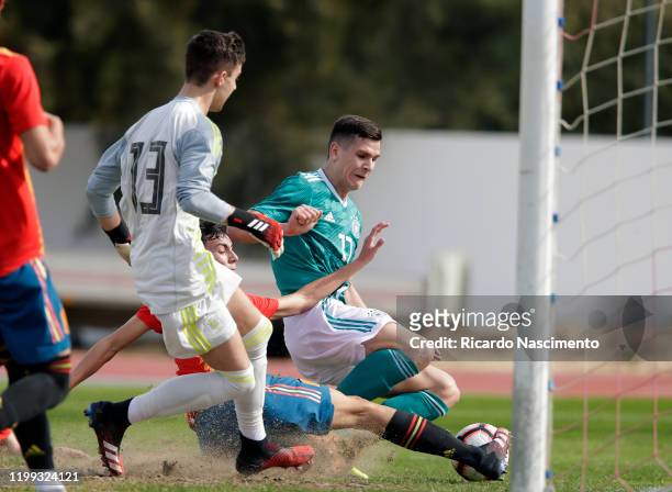 Igor Matanovic of Germany U17 battles for the ball with Miguel Angel Sanz and Adrian Corral Alciturri of Spain U17 and scores a goal on February 8,...