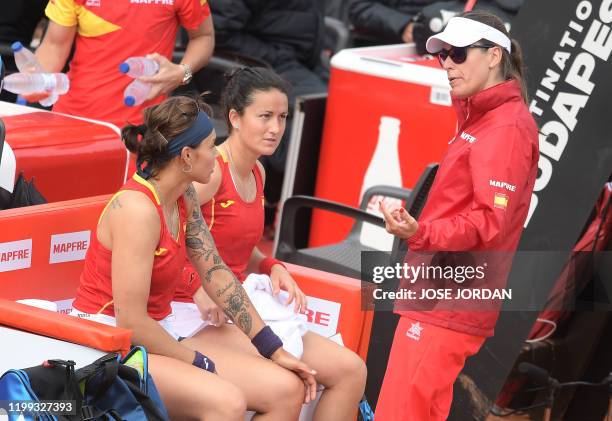 Spain's Aliona Bolsova and Lara Arruabarrena listen to Spain's captain Anabel Medina during their Fed Cup qualifier doubles tennis match against...