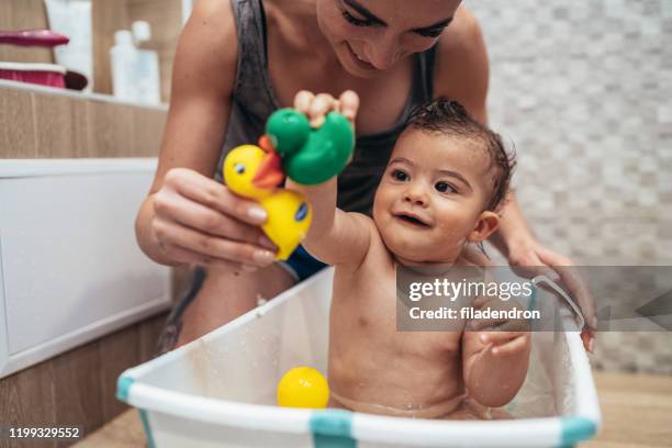 mother and baby bathtime - baby bath toys stock pictures, royalty-free photos & images