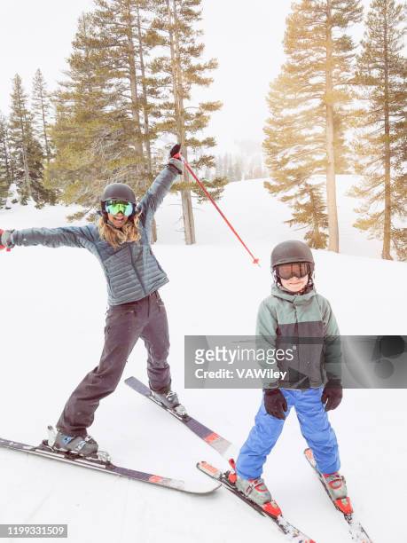 a young mom couple take their child skiing in truckee, california - lake tahoe skiing stock pictures, royalty-free photos & images