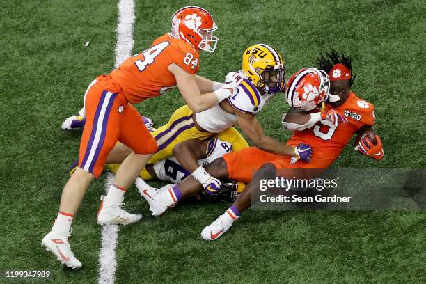 Travis Etienne of the Clemson Tigers is tackled by Grant Delpit of the LSU Tigers during the second quarter in the College Football Playoff National...