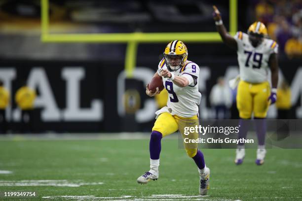 Joe Burrow of the LSU Tigers runs the ball against the Clemson Tigers during the College Football Playoff National Championship game at Mercedes Benz...