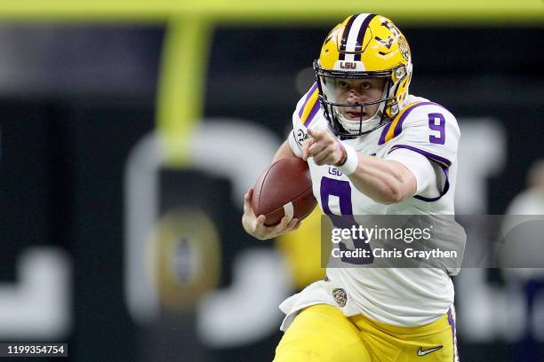 Joe Burrow of the LSU Tigers runs the ball against the Clemson Tigers during the College Football Playoff National Championship game at Mercedes Benz...
