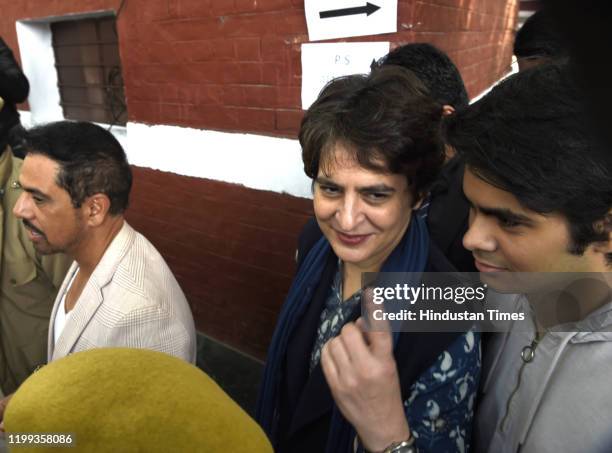 Congress Party General Secretary Priyanka Gandhi Vadra along with husband Robert Vadra and their son Raihan Vadra show finger marked with indelible...