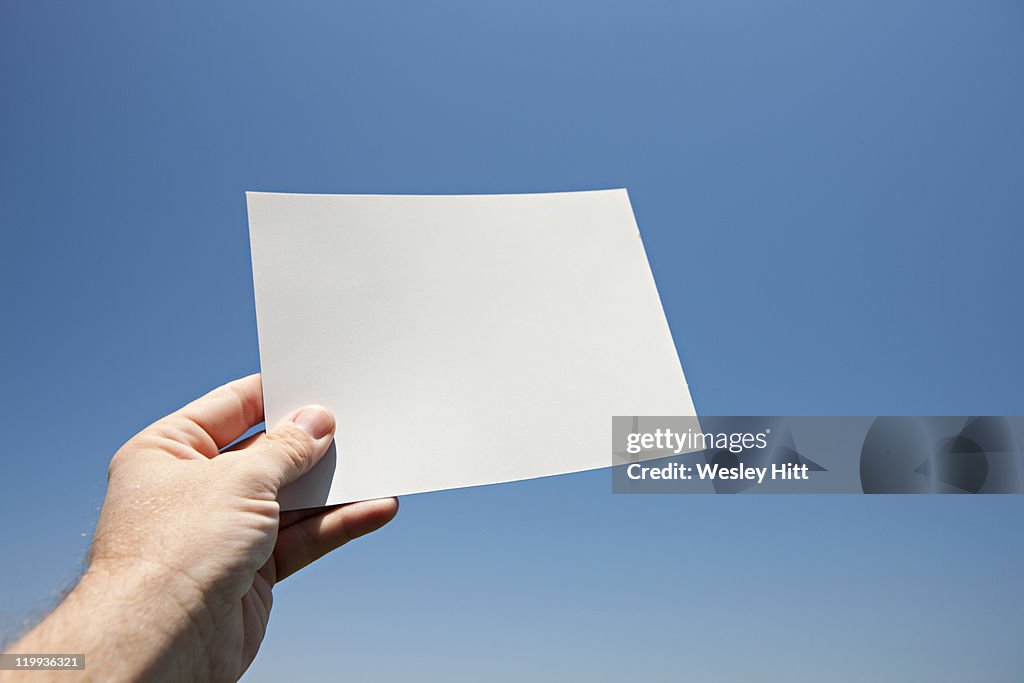 Hand holds a white card