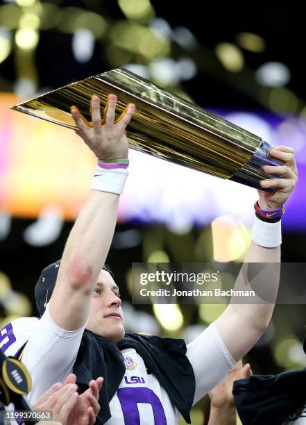 Joe Burrow of the LSU Tigers celebrates with the trophy after defeating the Clemson Tigers 42-25 in the College Football Playoff National...