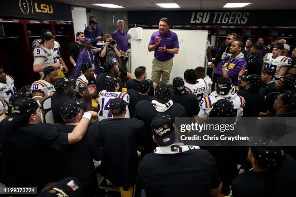 Head coach Ed Orgeron of the LSU Tigers talks to his team in the locker room after their 42-25 win over Clemson Tigers in the College Football...