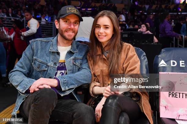 Lily Collins and Charlie McDowell attend a basketball game between the Los Angeles Lakers and the Cleveland Cavaliers at Staples Center on January...