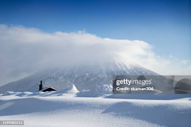 beautiful landscape view of little fuji mountain yotei  cover by snow and village near niseko hokkaido japan 2020 - japan skiing stock pictures, royalty-free photos & images