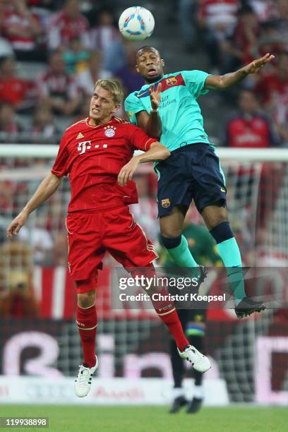 Nils Petersen of Bayern and Seydou Keita of Barcelona go up for a header during the Audi Cup final match between FC Bayern Muenchen and FC Barcelona...