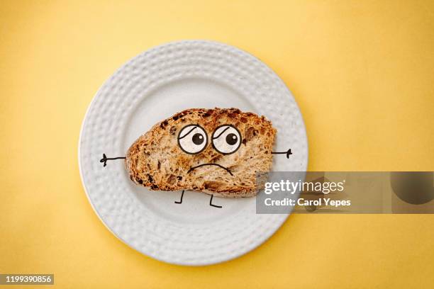 top view toast bread with sad face  in yellow background - sans gluten photos et images de collection