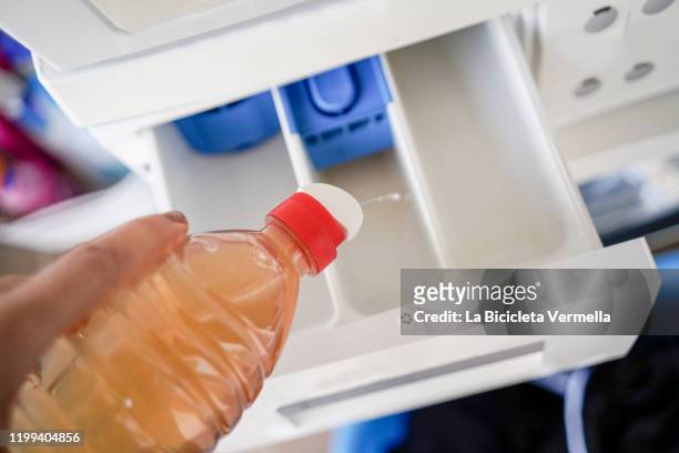 putting vinegar in the washing machine - washing machine photos et images de collection