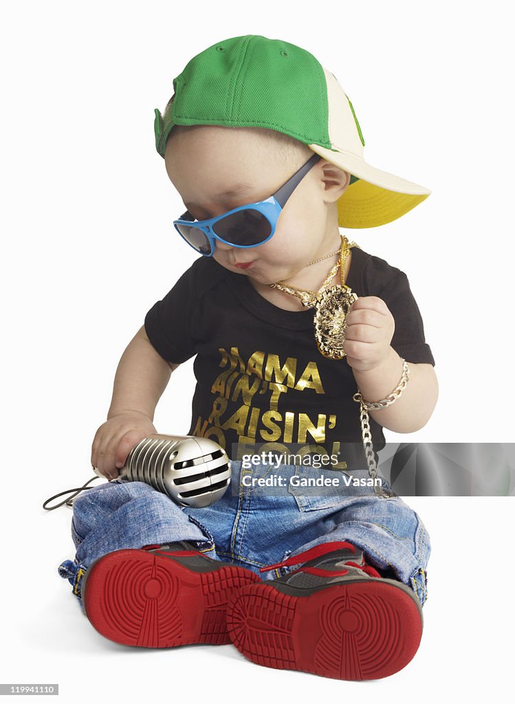 Baby dressed as urban rapper seated