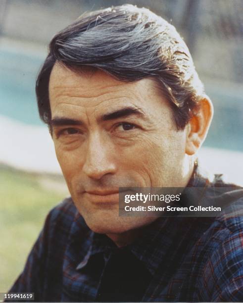 Headshot of Gregory Peck , US actor, wearing a dark plaid shirt, circa 1965.