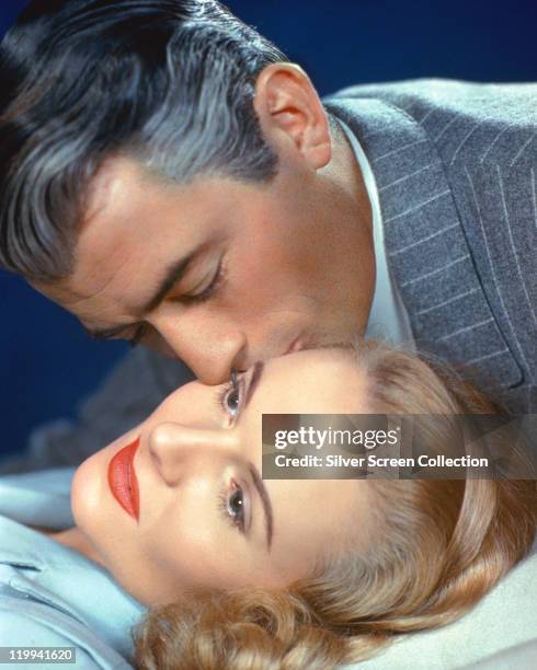 Gregory Peck , US actor, kisses Ann Todd , British actress, in a publicity still issued for the film, 'The Paradine Case', 1947. The courtroom drama,...