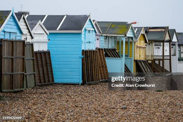 The decking in front of the beach huts is flipped up against the doors to protect it from the weather on Lancing Green beach as Storm Brendan heads...