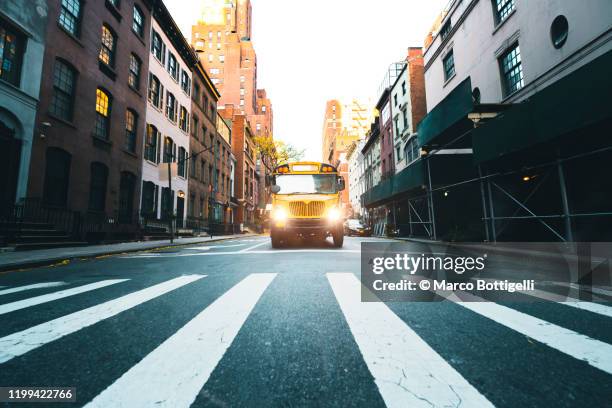 yellow school bus in new york city - low angle view street stock-fotos und bilder