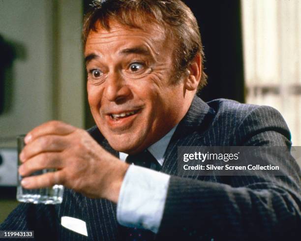 Herbert Lom, Czech actor, holding a drinking glass in a publicity still issued for the film, '99 Women', 1969. The prison drama, directed by Jesus...