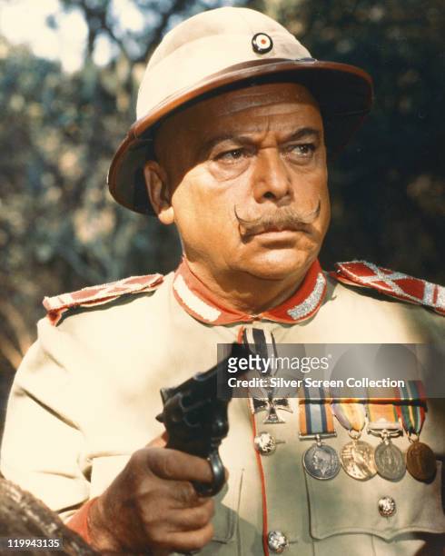 Herbert Lom, Czech actor, wearing German military uniform while holding a handgun in a publicity still issued for the film, 'King Solomon's Mines',...