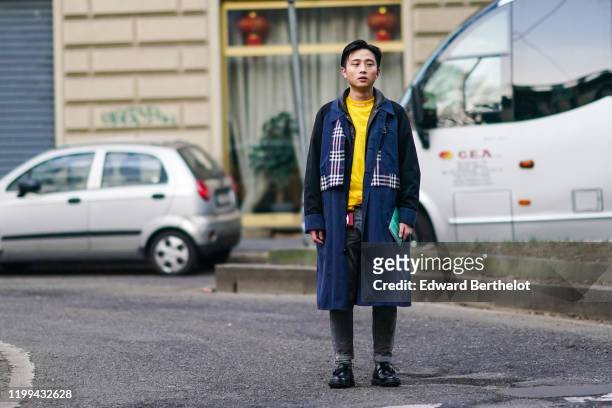 Guest wears a dark blue coat with black sleeves and checked pattern parts, a yellow top, black denim pants, black leather shoes, outside Reshake,...