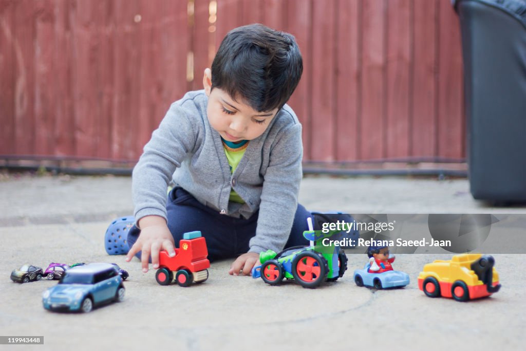 Toddler boy playing with cars