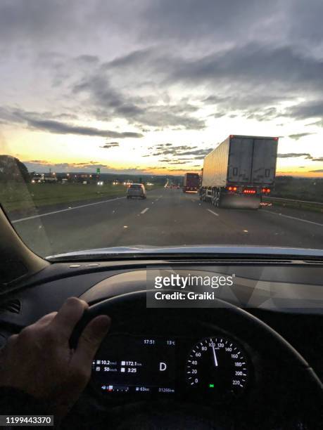 point of view of a driver on the highway by sunset - truck front view stock pictures, royalty-free photos & images
