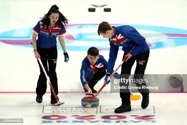 Switzerland Hanna Farries, Ross Craik and Jamie Rankin of Great Britain play a rock in their Mixed Team Round Robin Group C Session 14 match against...