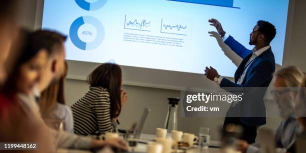 african-american businessman giving a presentation - sales pitch stock pictures, royalty-free photos & images