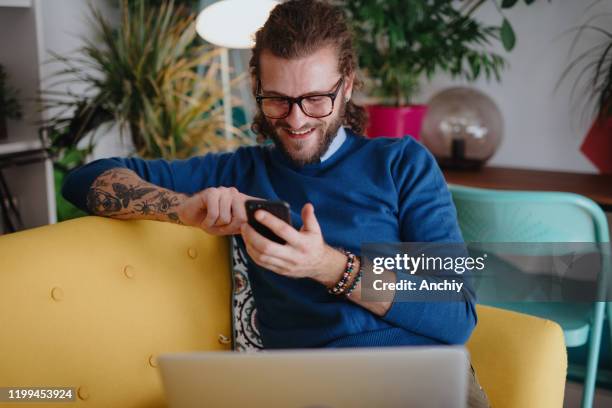 millennial man shopping online - millennials at work stock pictures, royalty-free photos & images