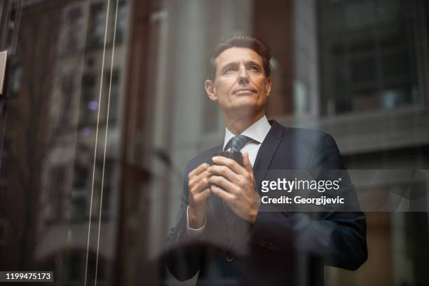 german businessman - looking through window - georgijevic frankfurt stock pictures, royalty-free photos & images
