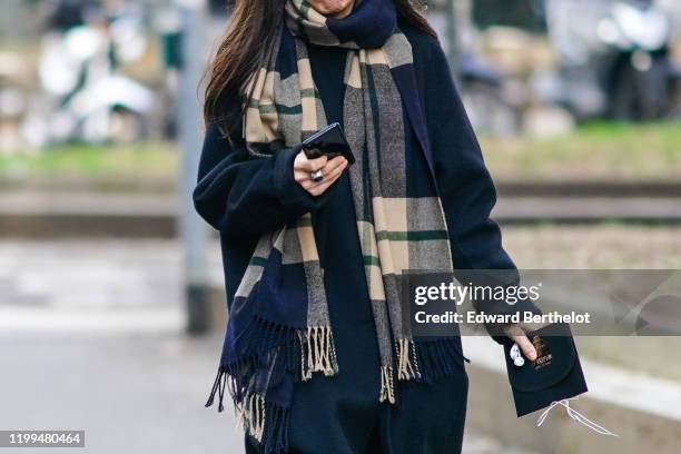 Guest wears a checked beige and blue scarf with fringes, outside Reshake, during Milan Fashion Week Menswear Fall/Winter 2020/2021, on January 13,...