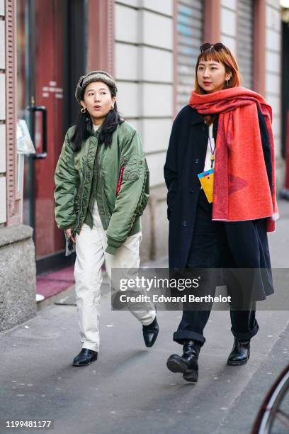 Guest wears a a fluffy hat, a green bomber jacket, white pants, black leather pointy shoes, earrings ; a guest wears sunglasses over the head, a red...