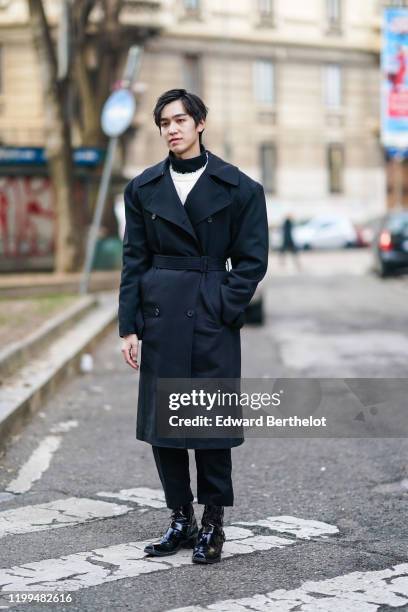 Chinese actor Yan Yu Hao, also known as Jerry Yan, wears a black double breasted long coat, a white pullover, a turtleneck, outside Reshake, during...