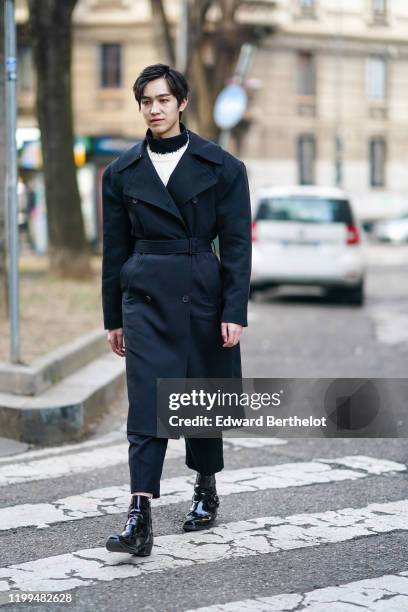 Chinese actor Yan Yu Hao, also known as Jerry Yan, wears a black double breasted long coat, a white pullover, a turtleneck, outside Reshake, during...