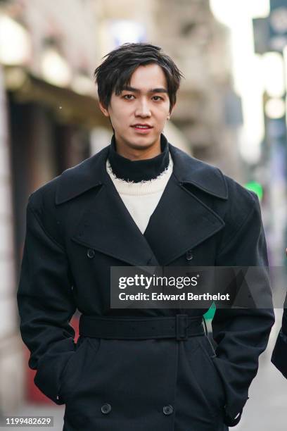 Chinese actor Yan Yu Hao, also known as Jerry Yan, wears a black double breasted long coat, a white pullover, a turtleneck, outside Reshake, during...