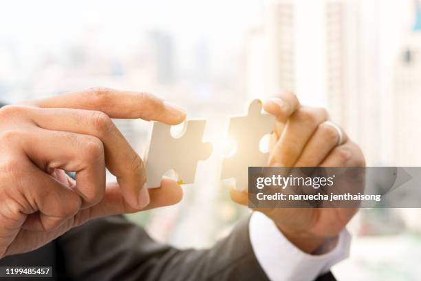 businessman hands connecting jigsaw puzzle. business solutions, success and strategy, learning concept. - 2 infographic stock-fotos und bilder