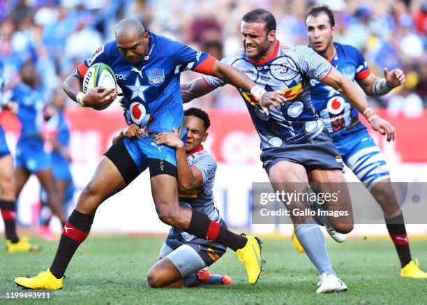 Cornal Hendricks of the Bulls tacked by Herschel Jantjies of the Stormers and Jamie Roberts of the Stormers during the Super Rugby match between DHL...