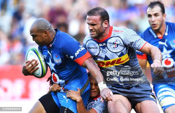 Cornal Hendricks of the Bulls tacked by Herschel Jantjies of the Stormers and Jamie Roberts of the Stormers during the Super Rugby match between DHL...