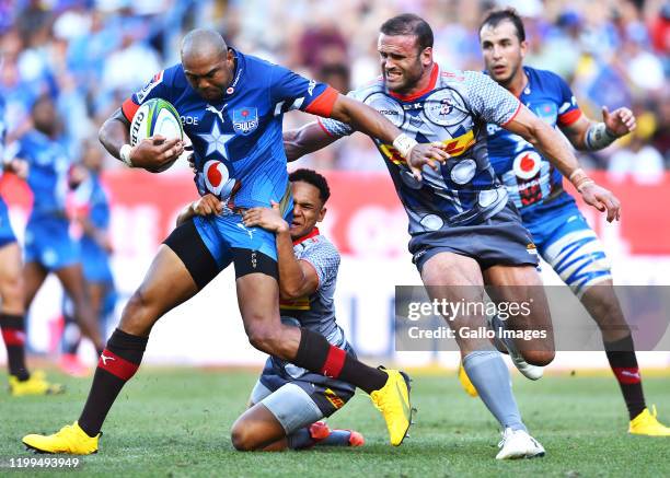 Cornal Hendricks of the Bulls tacked by Herschel Jantjies of the Stormers and Jamie Roberts of the Stormers during the Super Rugby match between DHL...