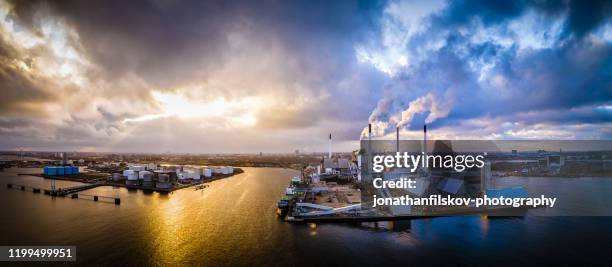 aerial shot of energy plant driven by sustainable biomass in copenhagen, denmark. this fossil free energy system is fueled biomass, a renewable energy source. aerial view shot with drone as hdr (high dynamic range). - biomass renewable energy source stock pictures, royalty-free photos & images