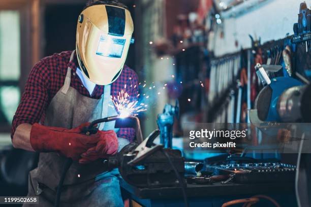mechanic using a welding torch - welding mask stock pictures, royalty-free photos & images