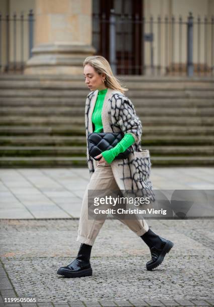 Sonia Lyson is seen wearing black boots Zara, cuffed creme white pants, green longsleeve H&M, Max Mara cardigan, Dior belt, black clutch Bottega...