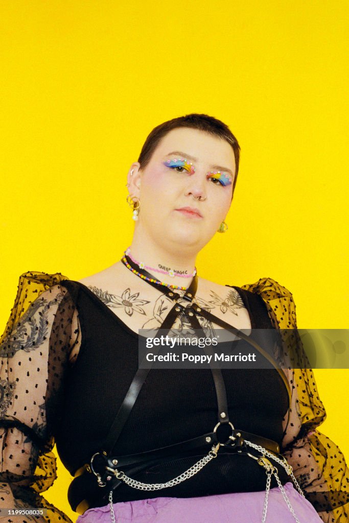 Colourful studio portrait of a young non-binary individual