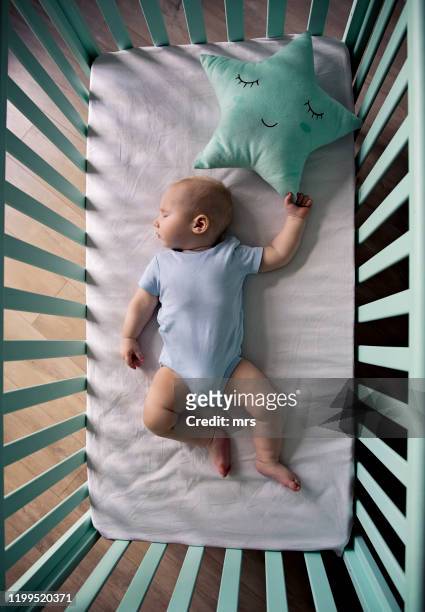 sleeping baby - above view of man sleeping on bed stock-fotos und bilder
