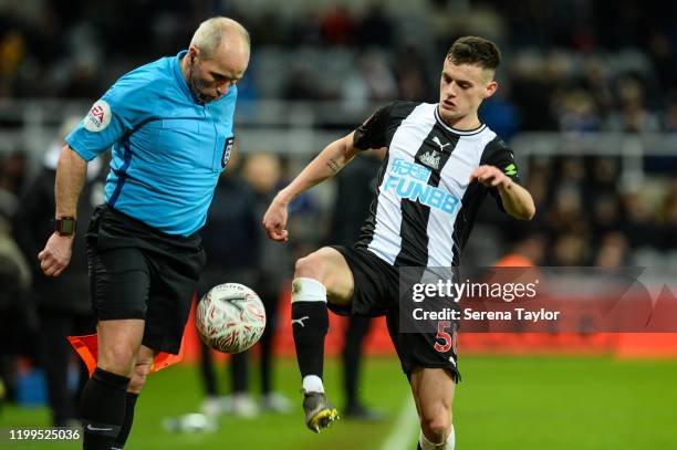 Newcastle United debut Tom Allan attempts to control the ball as Assistant Referee Richard West is in the way during the FA Cup Third Round Replay...
