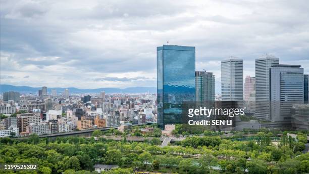 cityscapes of the skyline in osaka, with garden park in foreground - osaka skyline stock pictures, royalty-free photos & images
