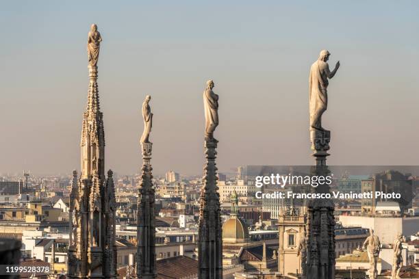 statues of duomo cathedral, milan, italy. - milan cathedral roof stock pictures, royalty-free photos & images