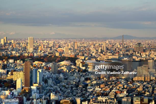 aerial view of tokyo cityscape at sunset - olympiastadion stock-fotos und bilder