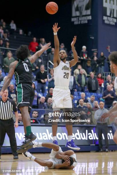 Akron Zips forward Xeyrius Williams buries the game winning 3-point shot over Eastern Michigan Eagles guard Yeikson Montero with 0:04.1 seconds left...