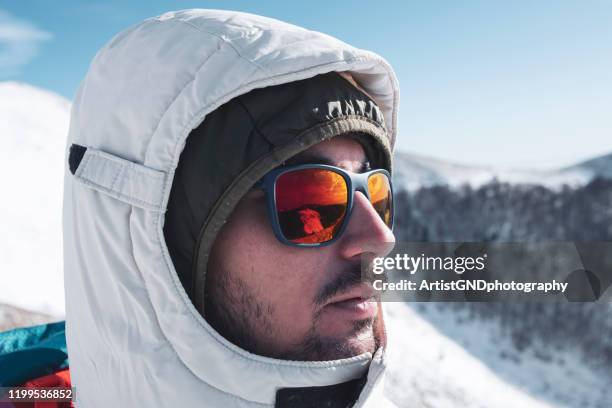 jonge bergbeklimmer met zonne glasen - face snow stockfoto's en -beelden